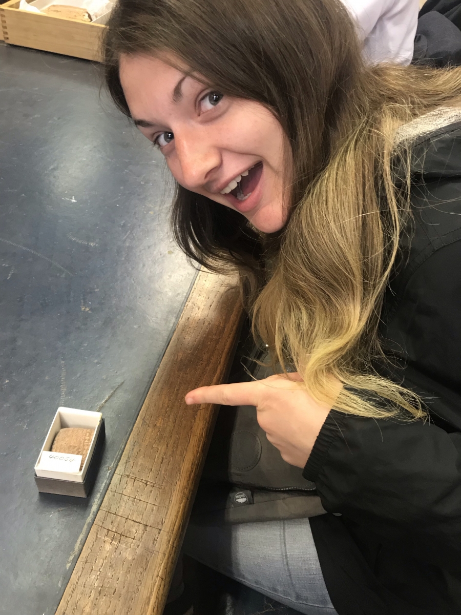 Student examining Babylonian tablet.