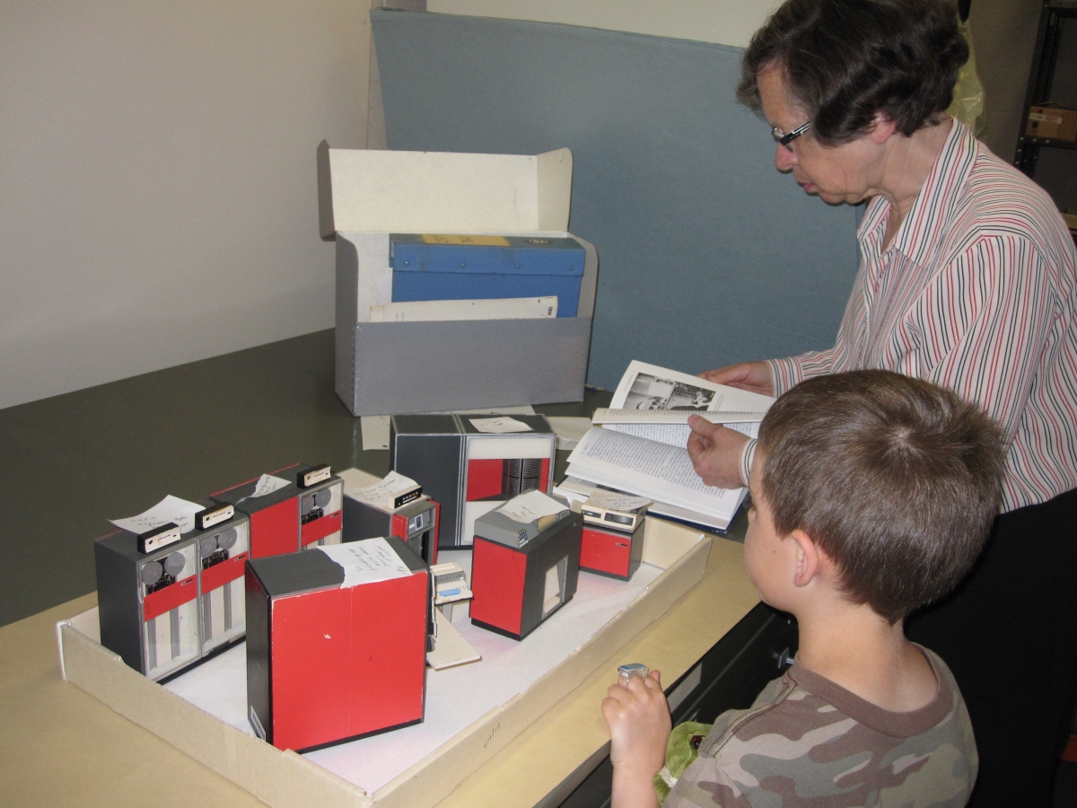 Peggy Kidwell demonstrates museum objects to Brian Gellasch.